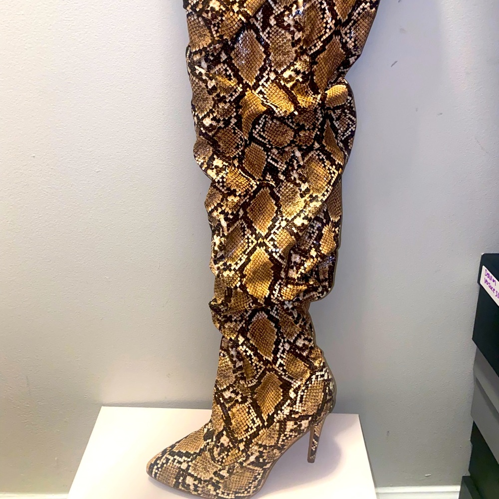 Snakeskin just fab over the knee boot. Great for fall collection